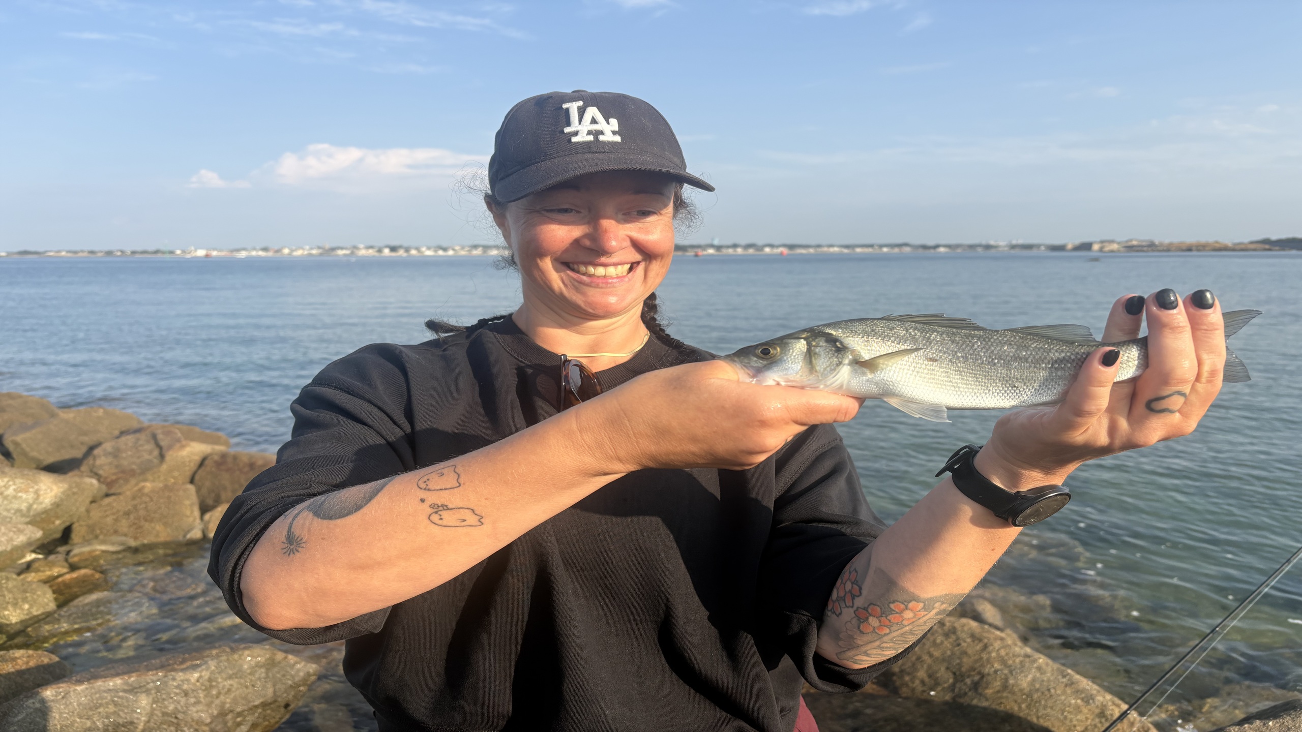 Esther avec son premier bar avec guide de pêche du bar Bretagne